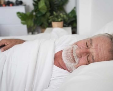 Older man sleeps well thanks to Inspire Therapy for sleep apnea.